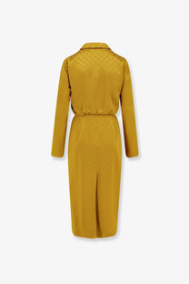 Back view of a mustard-yellow gucci trench coat in smooth satin with subtle interlocking g pattern on back and collar