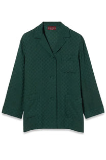Dark green Gucci women’s jacquard blazer with subtle repeating GG monogram pattern across the fabric