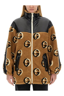 Gucci women’s jacquard zipper jacket beige with tan shearling and black and white logo pattern glossy panels