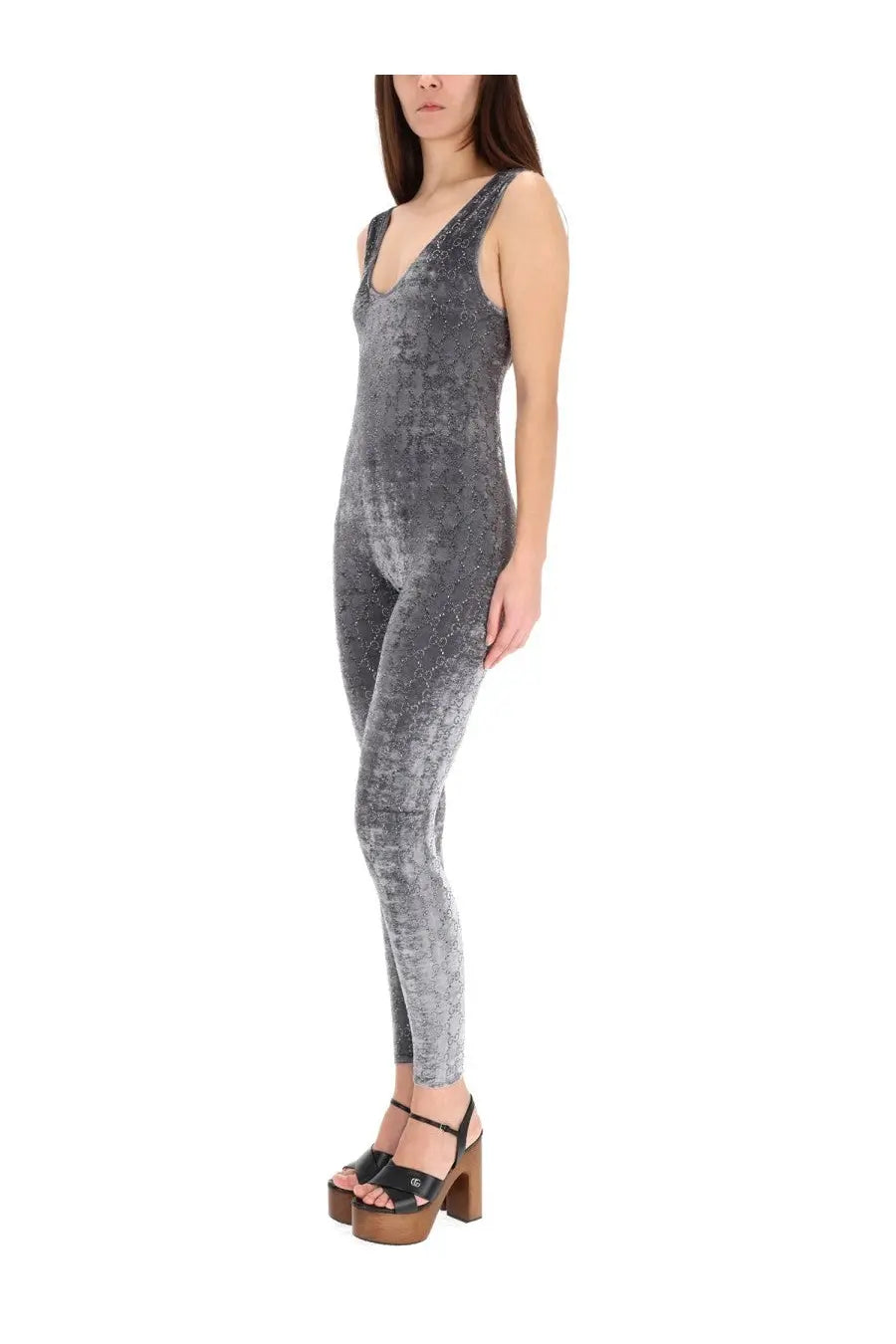 Gucci women’s gray velvet jumpsuit with subtle snakeskin pattern and deep v neckline in a sleek design