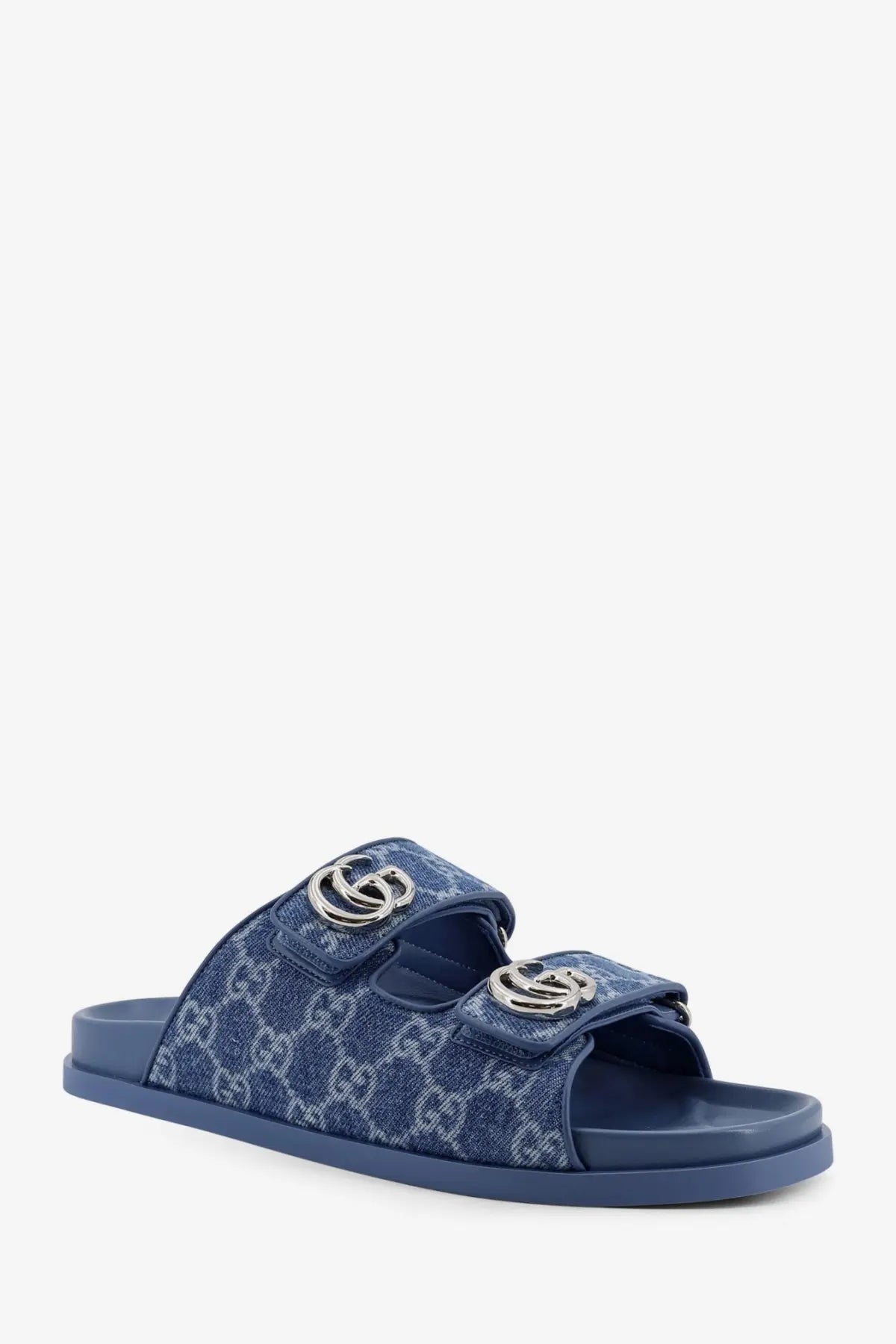 Gucci women’s laser GG denim sandals in blue with silver-toned interlocking G buckle slides