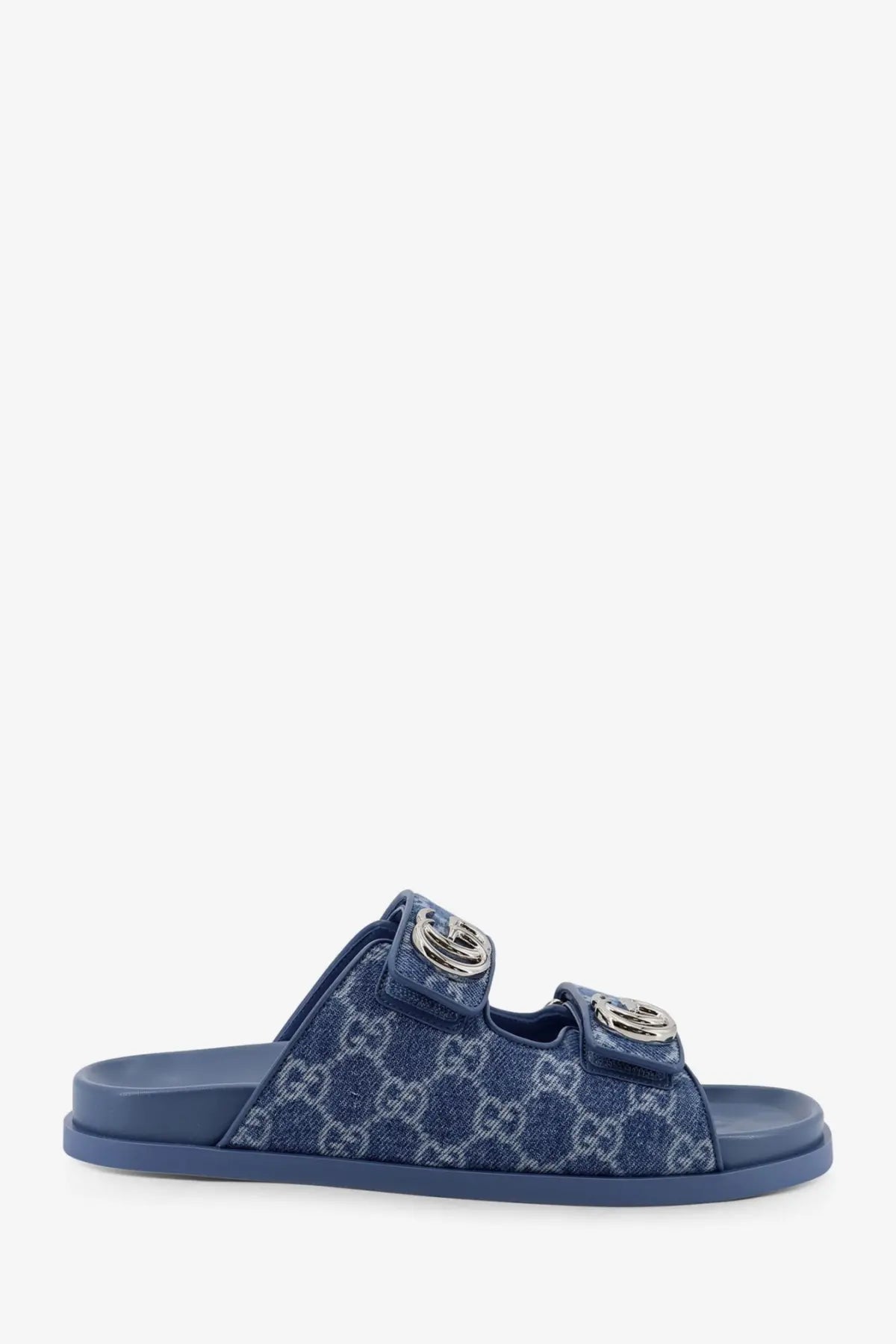 Blue denim-patterned gucci women’s slide sandal with silver-toned double g buckles and laser gg design