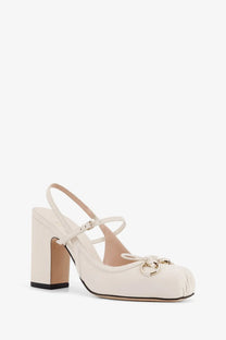 Cream-colored gucci women’s leather mary jane pump with block heel and gold-tone horsebit detail
