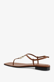 Gucci women’s Lifford yellow leather t-strap sandal with metallic chain-link detail and low black heel