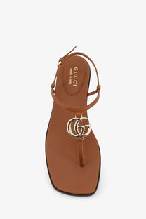Brown gucci leather thong sandal with metallic interlocking gg logo charm from gucci women lifford yellow collection