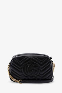 Black quilted Gucci marmont matelassé leather camera bag with gold-tone chain strap for women crossbody use