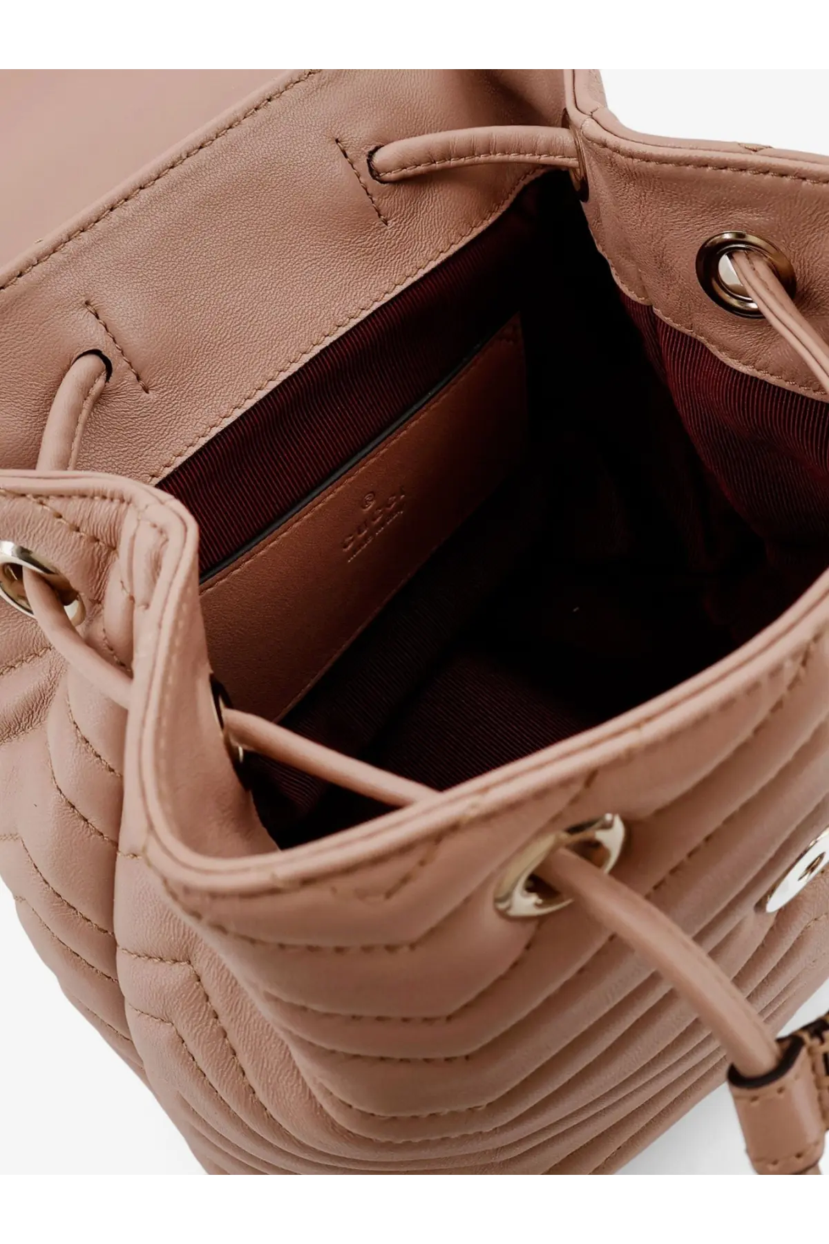 Gucci women’s mini GG Marmont leather backpack in quilted blush pink leather with drawstring closure and gold hardware