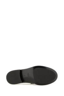 Back side of gucci women’s moccasin black showing smooth matte black rubber sole with subtle heel branding