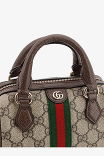 Gucci women’s Ophidia trunk bag beige featuring brown leather top handle gold hardware and red green striped webbing