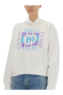 White Gucci women’s printed cotton hoodie with bold colorful logo print featuring purple and blue accents
