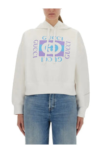White gucci women’s printed cotton hoodie featuring a bold purple and blue logo print across the chest