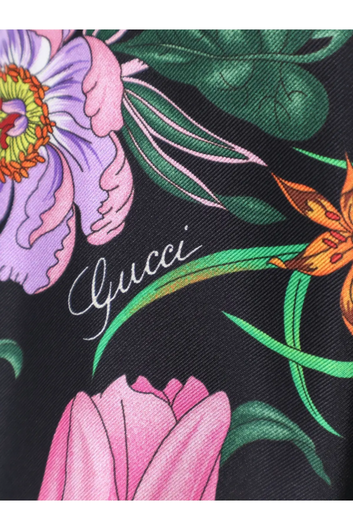 Black Gucci women’s printed silk shirt featuring a vibrant floral pattern with purple pink green and orange blossoms