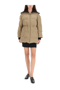 Beige gucci women’s quilted down jacket with black hood and trim featuring the signature gg monogram pattern
