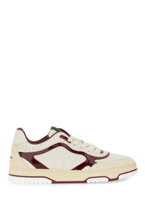 Cream and burgundy Gucci women’s low-top sneaker with glossy patent leather panel perforated suede overlays and white laces