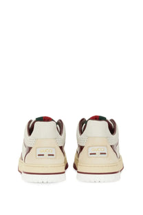Cream-colored Gucci women’s RE Web sneaker with brown accents and perforated leather uppers in white design