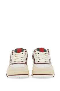 Cream-colored Gucci women’s RE Web sneaker with white laces, burgundy and green tongue accents, and chunky sole