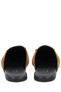 Gucci women’s sabot brown tan suede mules with black rubber soles shown from the back side