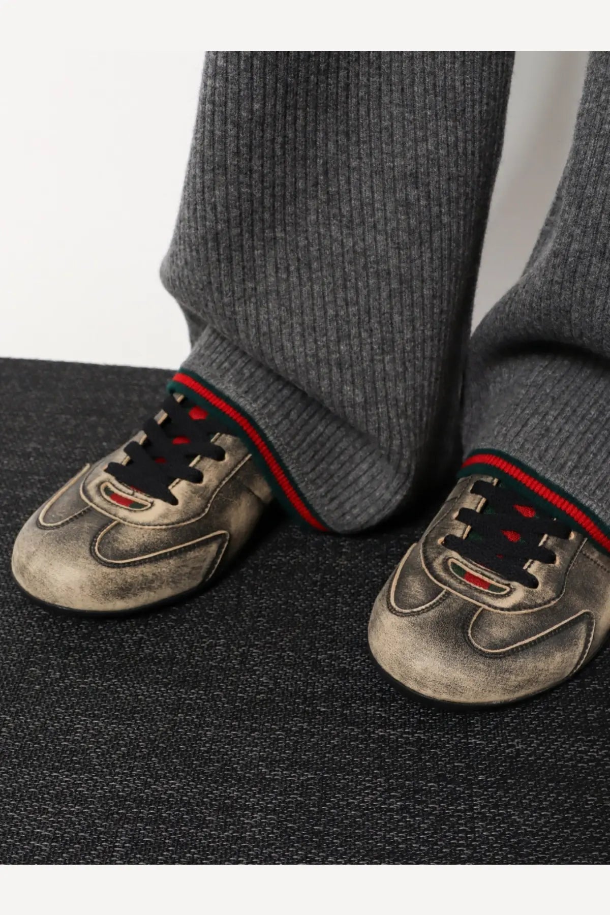 Worn-out gray suede Gucci women’s sneakers with red and green striped lace accents and leather details