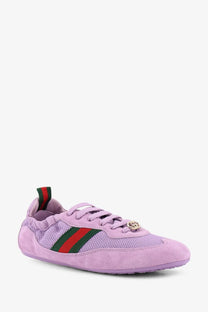 Lavender Gucci women’s sneaker with mesh and suede upper, red green striped webbing, and gold GG logo eyelet