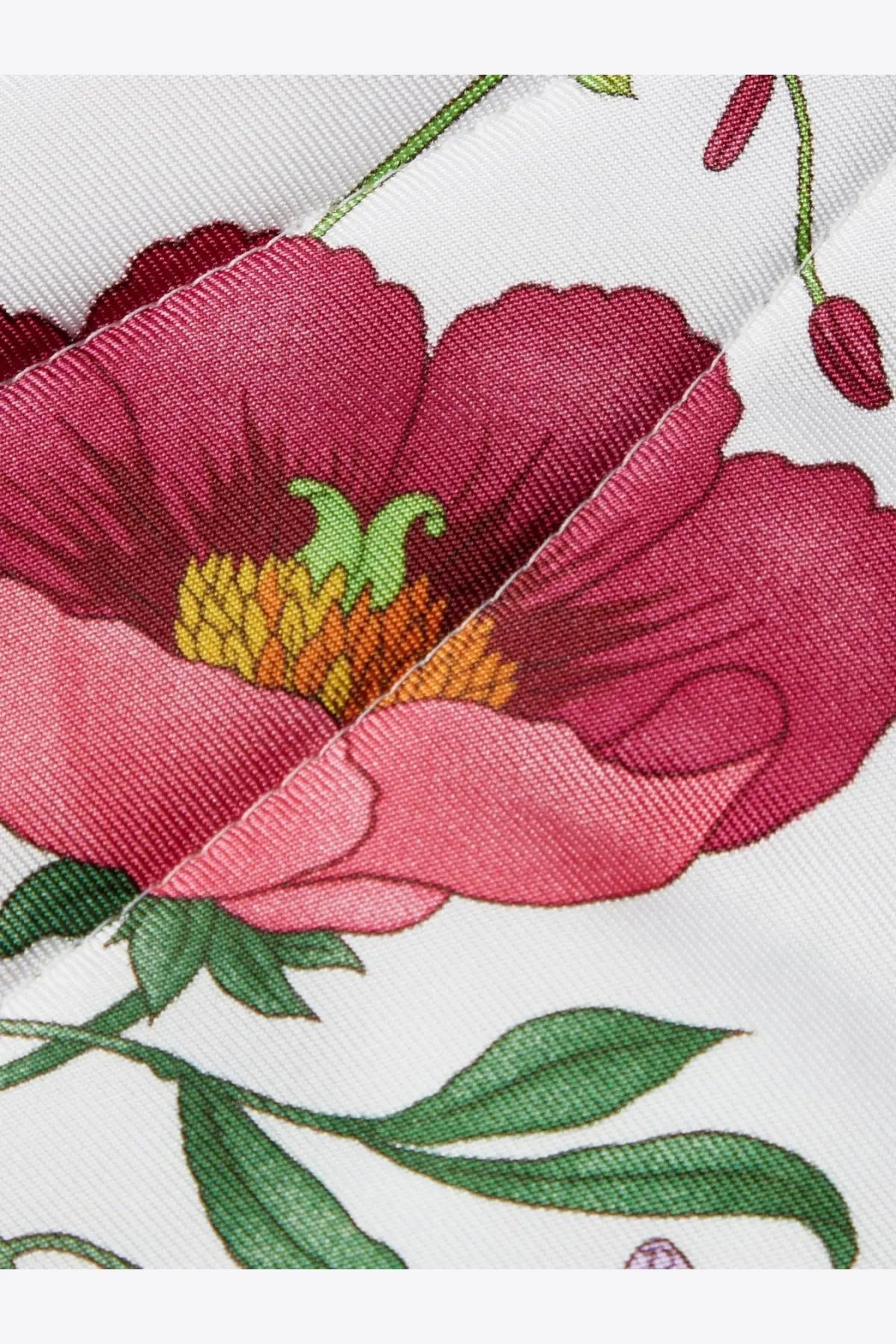 Gucci women’s black silk hair band with a vibrant pink poppy flower and yellow green center printed on white silk
