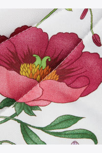 Gucci women’s black silk hair band with a vibrant pink poppy flower and yellow green center printed on white silk