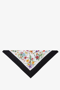 Gucci women’s silk hair band in black featuring a white triangular scarf with vibrant floral pattern and black border