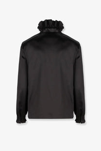 Gucci women’s silk blouse in black satin featuring a ruffled high collar and matching ruffled cuffs