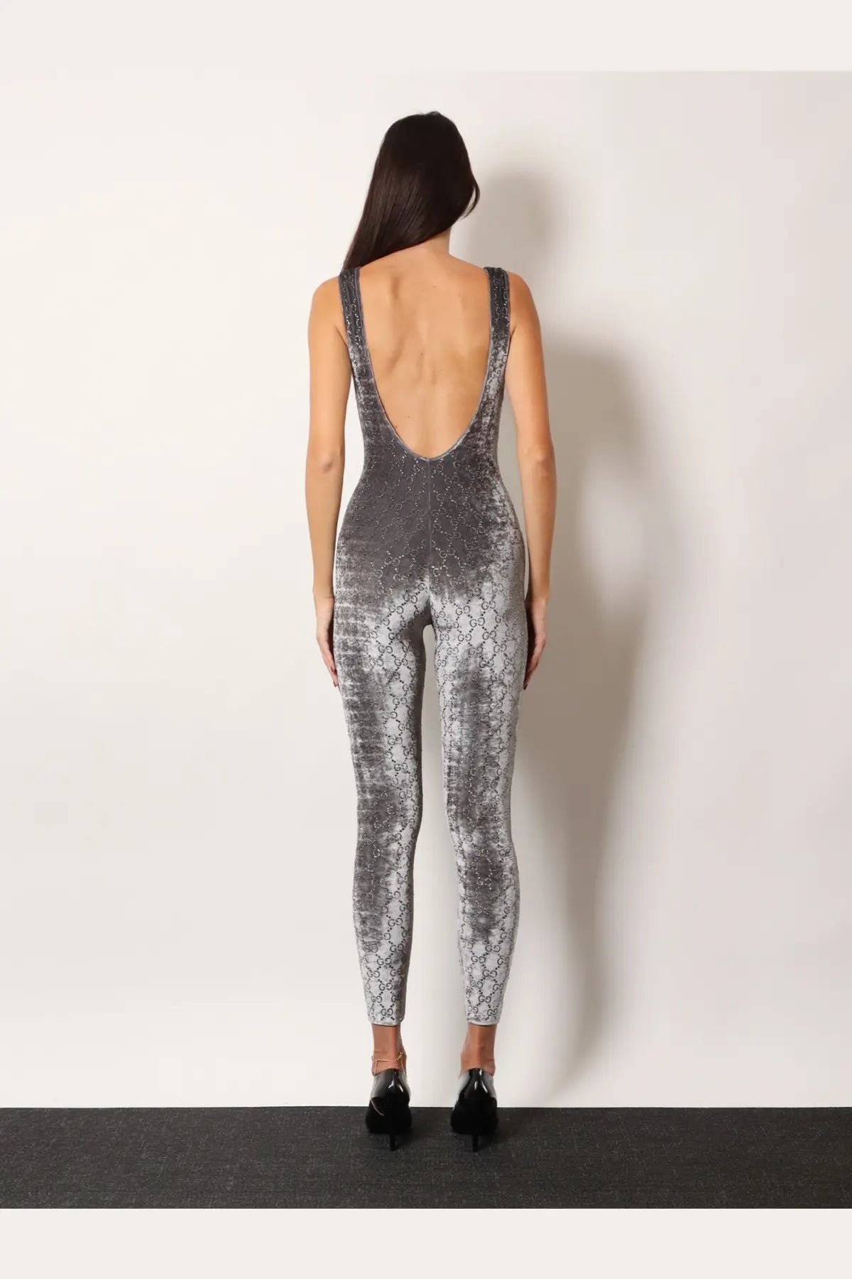 Back side of a sleek gray and black snakeskin-patterned gucci women’s stretch chenille jumpsuit with deep cutout