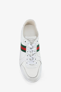 White leather gucci women’s stretch sneakers with classic green and red striped accents along the side
