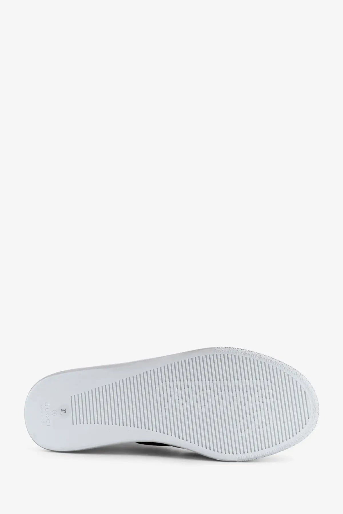 White rubber sole with textured ribbed pattern and embossed logo on gucci womens stretch leather sneakers white back side