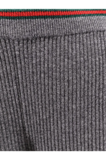 Grey ribbed knit sweater with red and green striped trim paired with gucci womens stretch wool trousers grey
