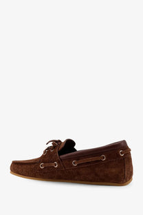 Gucci women’s suede loafers in brown with a subtle repeating logo pattern and metallic eyelets boat shoe design