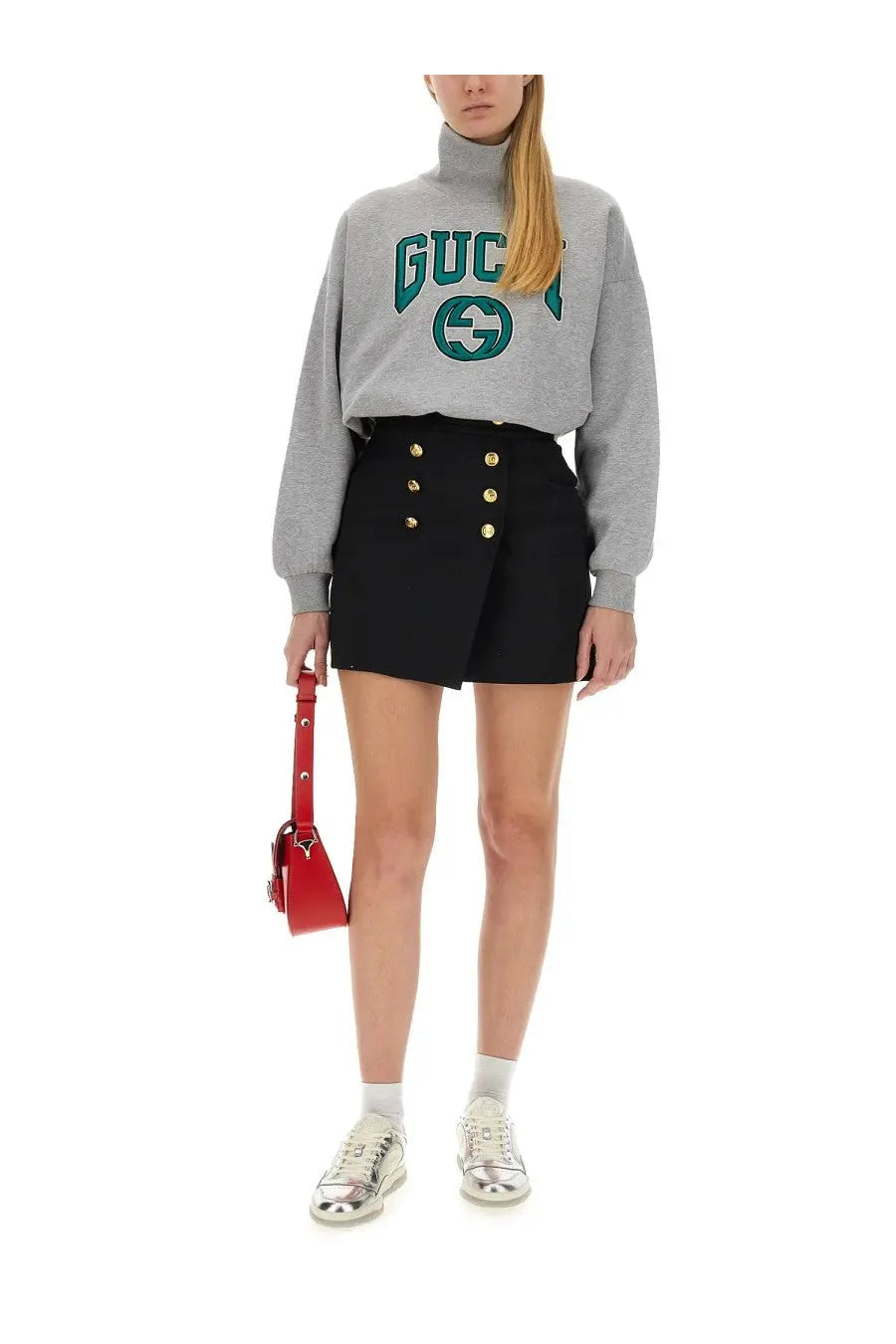 Red leather mini bag with silver hardware paired with gucci women’s grey sweatshirt front view