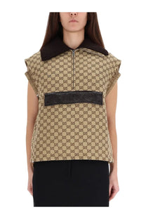Beige Gucci women’s vest with brown interlocking GG pattern black leather belt across chest and plush collar