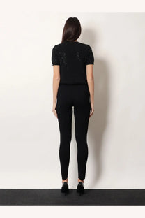 Black short-sleeved top with sparkling embellishments paired with gucci womens viscose blend leggings black