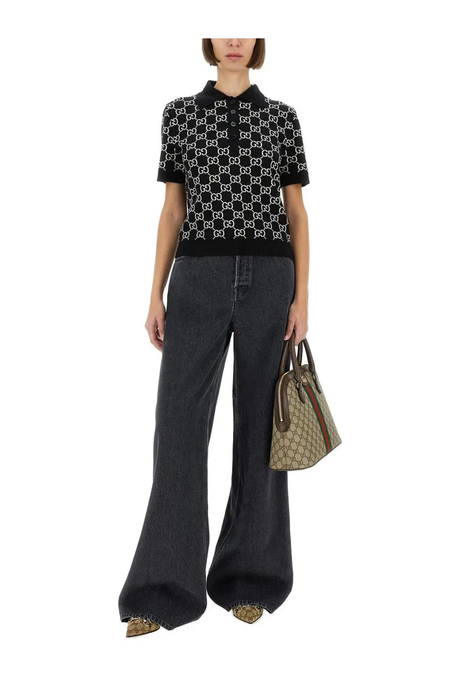 Black and white gucci gg supreme patterned knit polo shirt paired with gucci women’s wide leg grey denim pants