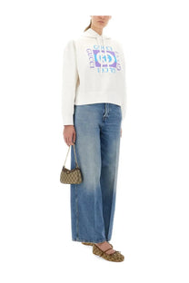 Beige and brown gucci gg supreme chain strap handbag styled with gucci women’s wide leg blue jeans