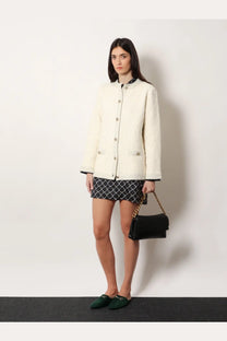 Black leather handbag with gold chain strap featured alongside gucci women’s white wool and cotton blend cardigan