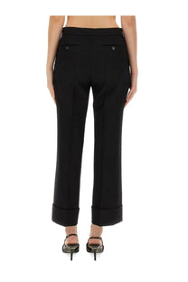 Gucci women’s black wool tailored trousers with straight-leg cut rolled cuffs and back pocket button details view from back