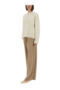 Cream-colored oversized knit sweater with ribbed cuffs and hem paired with guest in residence women’s beige pants everywear
