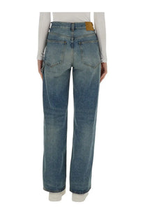 Haikure women’s high-waisted faded blue denim jeans with straight-leg cut and brown leather brand patch at waistband