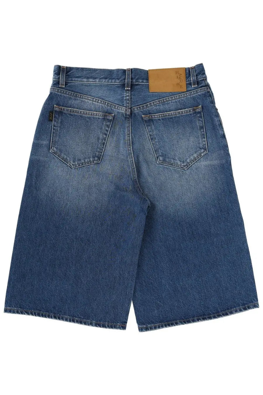 Back side of haikure women’s new becky denim shorts in blue with faded wash and classic back pockets
