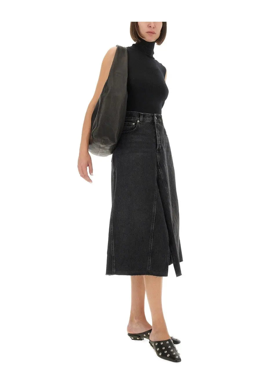 Black denim midi skirt by haikure with a front slit and raw hem ideal for casual and chic outfits