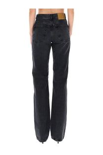 Haikure women’s star black wide-leg denim pants with faded wash and tan leather patch on waistband back view