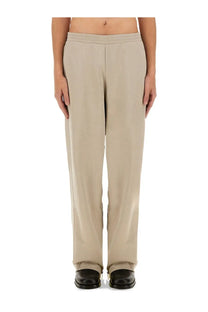 Helmut Lang men’s jogging pants grey with smooth lightweight fabric beige wide-leg trousers and subtle side seam detailing