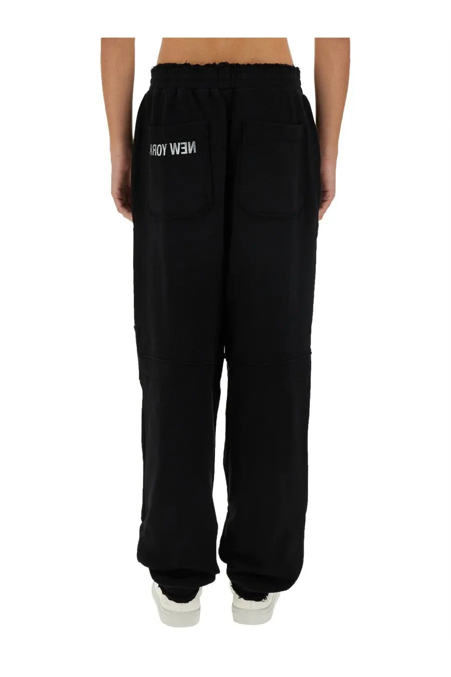 Back view of helmut lang men’s black sweatpants with elastic waistband and white new york embroidery on pocket