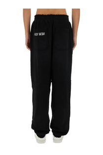 Back view of helmut lang men’s black sweatpants with elastic waistband and white new york embroidery on pocket