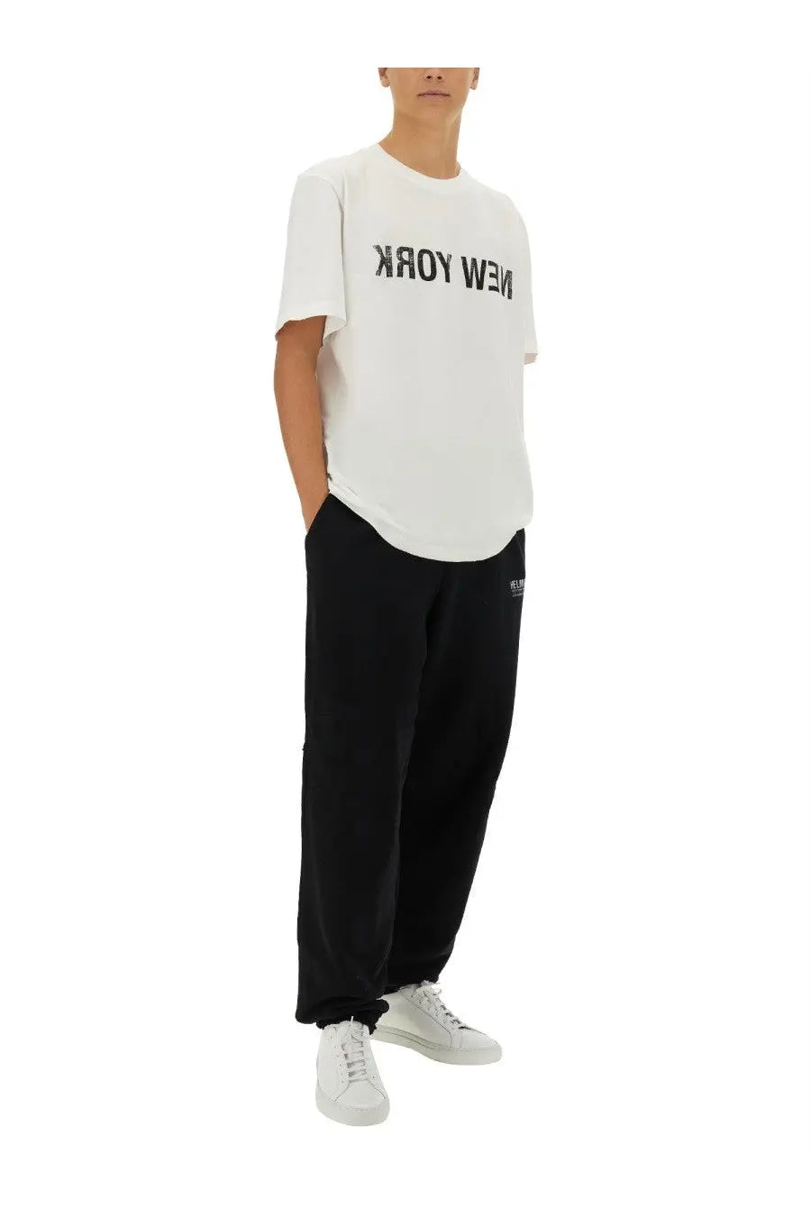 Helmut lang men’s black pants paired with a white cotton t-shirt featuring bold black new york lettering across the chest