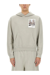 Helmut Lang men’s grey hoodie with a rectangular street scene photo patch on the chest in light gray fabric