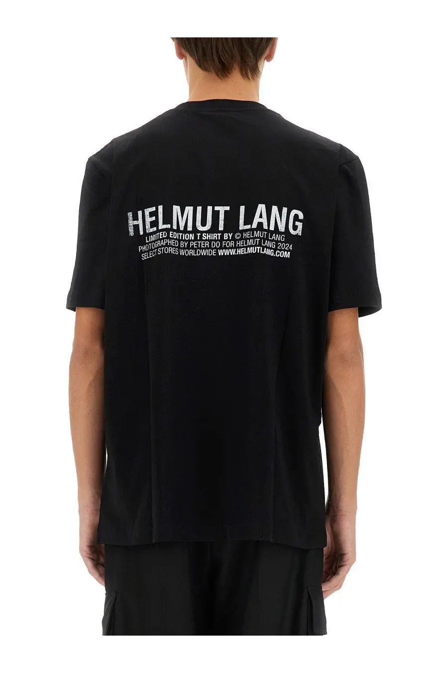 Back side of helmut lang men’s black limited edition t-shirt with white distressed text across the back